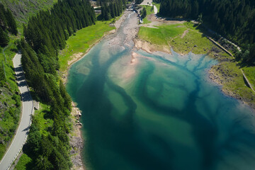 aerial view of the branches of the lake of paneveggio trentino and bridge in the background