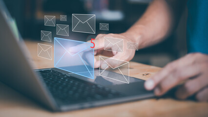 Businessman using laptop to open e-mail via virtual screen, Internet messaging concept, social...
