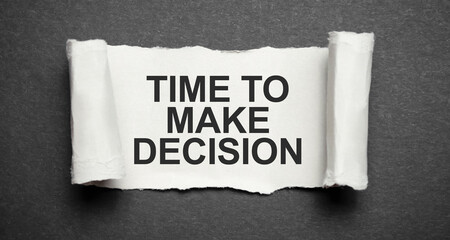 The word TIME to make decision is standing on a black background, ripped paper