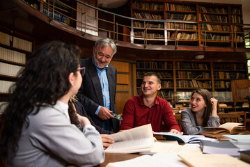 The senior professor gives a lecture to the students at the University library