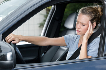Fototapeta na wymiar woman with headache in a car