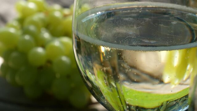 white wine glass with grapes, sparkling prosecco outdoor