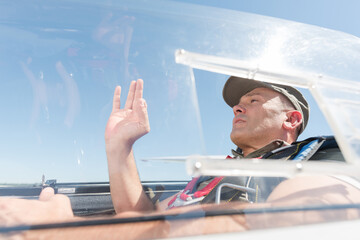 man in glider making positive gesture