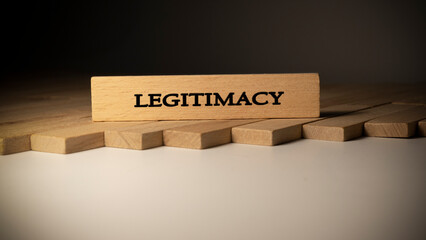 Legitimacy was written on a wooden surface. Finance and politics