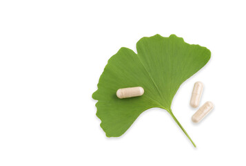 Ginkgo leaf with pills isolated on white for brain, memory protect therapy and treatment of dementia. Ginkgo Biloba composition - natural ingredient for alternative medicine, closeup. - 525937001