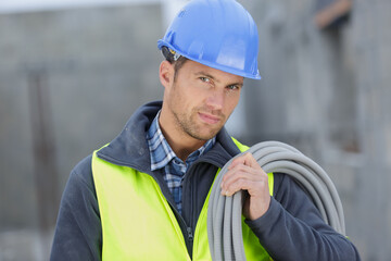 handsome man electrician wiring cable outdoors