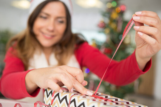 Woman Finishing A Christmas Gif Box