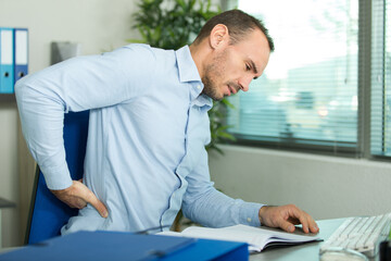 man with aching waist i the office