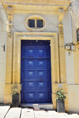Traditional colorful front blue door in capital city of Valletta, Malta