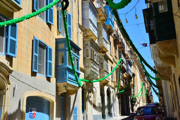 Street view of Valletta; traditional colorful balconies in the old city of Valletta, Maltese residential architecture, windows