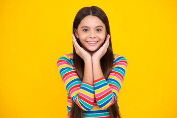 Happy face, positive and smiling emotions of teenager girl. Emotional portrait of caucasian teenager child girl isolated on studio yellow background.
