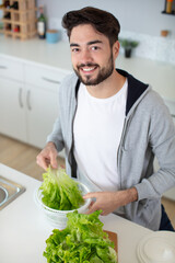 Fototapeta premium man preparing to spin washed lettuce