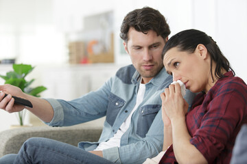 couple watching soap opera in evening