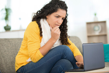 woman using laptop in the sofa stressed about something