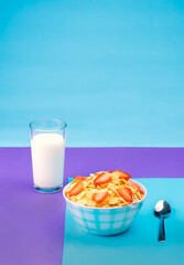 Plate of whole grain cereal with strawberries and a glass of fresh milk for breakfast.
