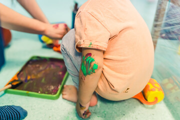 closeup view of a kid with painted hands at nursery. High quality photo