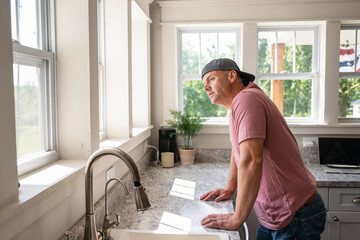 Marine veteran at home with family on a early morning in the kitchen.