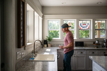 Marine veteran at home with family on a early morning in the kitchen.