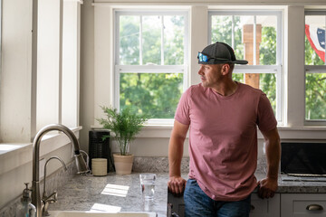 Marine veteran at home with family on a early morning in the kitchen.