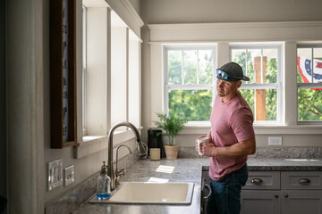Marine veteran at home with family on a early morning in the kitchen.