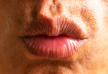 Tanned Asian man's lips make a sudden mouth close up