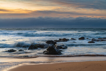 Cloud covered sunrise sesacape in soft pastel shades