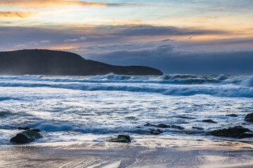 Cloud covered sunrise sesacape in soft pastel shades