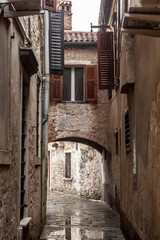 Fototapeta premium Typical mediterranean old narrow street with southern european architecture, with ancient buildings, in the old town of piran or Pirano, in Slovenia, a city of Istria, on Adriatic sea....
