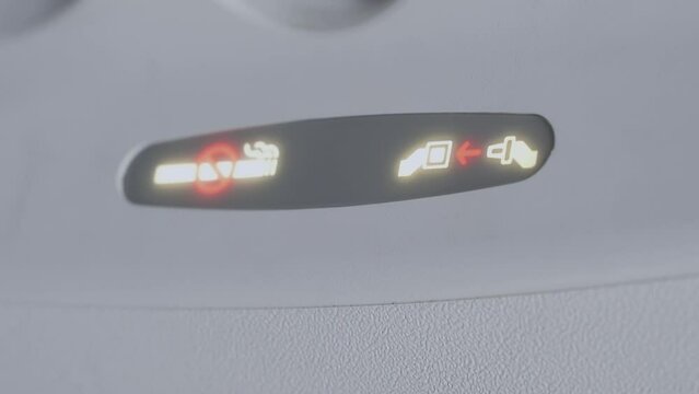 Airplane interior, signs fasten your seat belt and no smoking