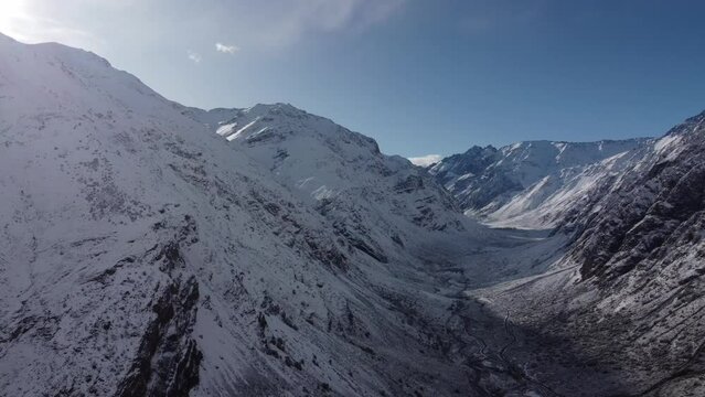 Trekking in winter season. Snowed mountains in La Egorda Valley, Caj n del Maipo, central Andes mountain range, Chile 