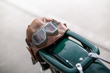 Old pilot, aviator hat, leather motorcycle helmet and glasses