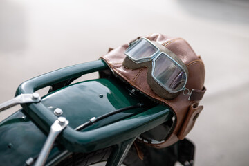 Old pilot, aviator hat, leather motorcycle helmet and glasses