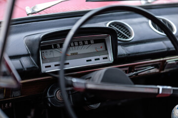 Naklejka premium dashboard, car interior, automatic tachometer of an old red car