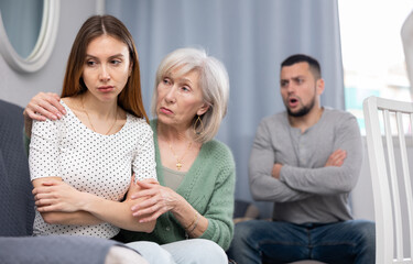 Elderly mother comforts her adult daughter after her quarrel with her husband - obrazy, fototapety, plakaty