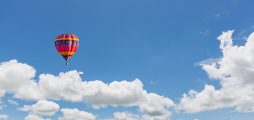 colorful hot air balloon in the sky in the morning, blue sky and clouds texture background
