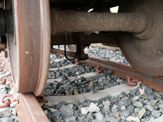 closeup of old train wheels on the train track.