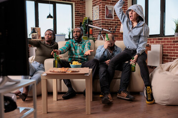 Frustrated soccer fans watching football team losing match game, feeling angry about lost championship. Sad supporters looking at sport competition on television, being disappointed about score.