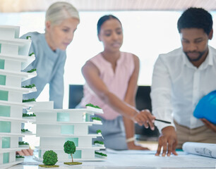 Architect or engineer team planning and designing a building in a meeting in the office or...