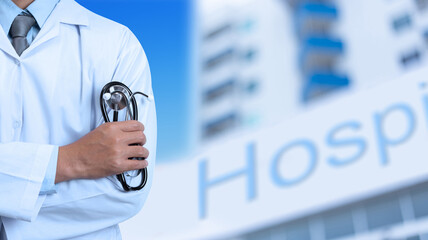 Doctor on blurred background of hospital building with red cross sign, concept of the healthy and medical © PRASERT