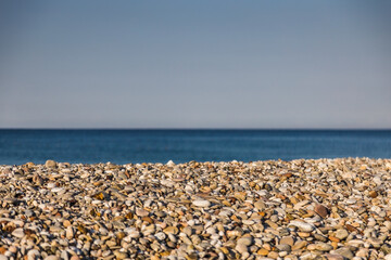 Sea pebbles against the blurred the sea.