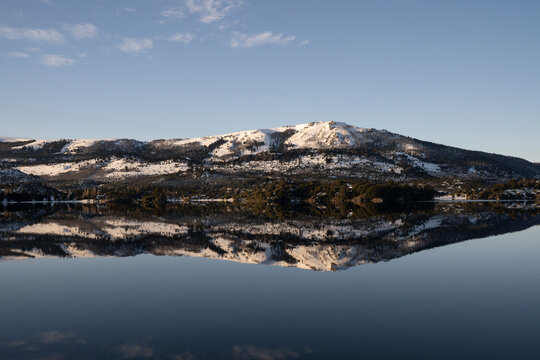 Magical view of the Andes mountains, forest and blue sky reflection in the lake at sunrise.	