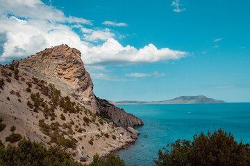 A scenic view of beach and coastal mountain against a clear blue sky in Senja, Norway. High quality photo