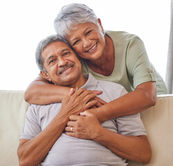 Senior couple portrait, love, and hug in relax home living room bonding in safety, security and trust. Elderly people, retirement and care for happy man and woman with smile on sofa in house interior