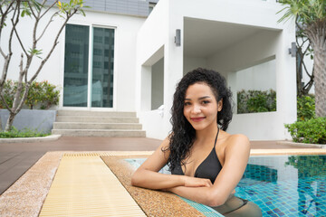  woman in the bikini at pool Swimming pool tanned slim and shapely body, Girl enjoying travel...