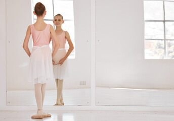 Young ballet dancer dancing in studio, doing dance performance before competition and learning...