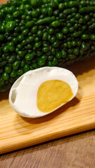 close-up of momordica charantia and salted duck egg