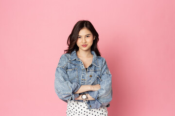 portrait beautiful asian woman smiling wearing long sleeve denim shirt on pink pastel wall, photo studio background, with copy space