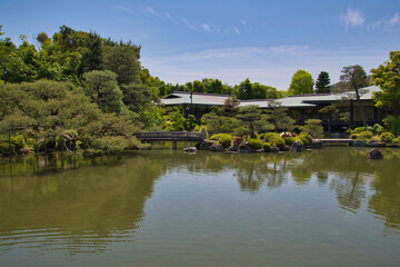 Fototapeta na wymiar The stone bridge and the garden pond of Shinen inside the Heian-Jingu shrine. Kyoto Japan 