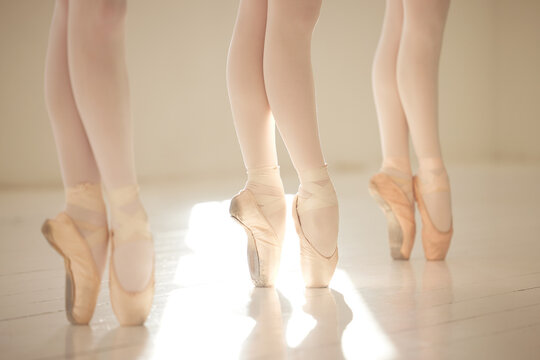 Ballet dance woman legs in studio training, exercise and working on performance for competition. Ballerina shoes, teamwork and creative art academy school students learning dancing routine