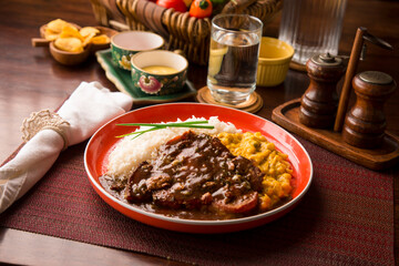 Fried cow liver with locro pumpkin stew Buffet table Peruvian comfort restaurant gourmet food